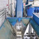 View of the Transfer from the Hopper to the Metal Belt Lift Conveyor